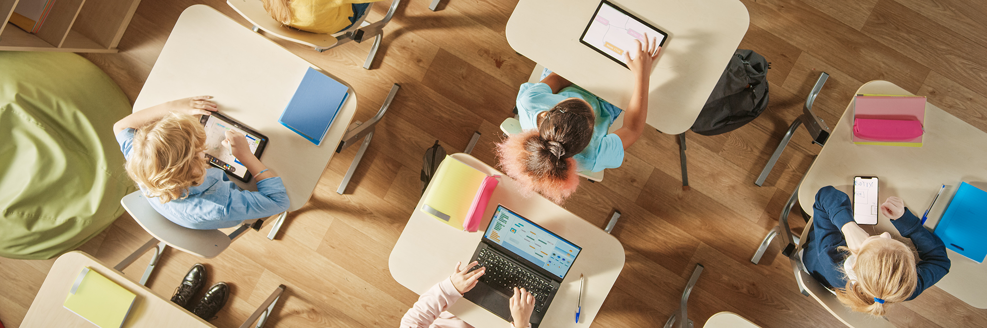 children at their desks with devices | The Digital Classroom