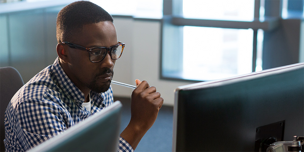 Man looking puzzled at his screen