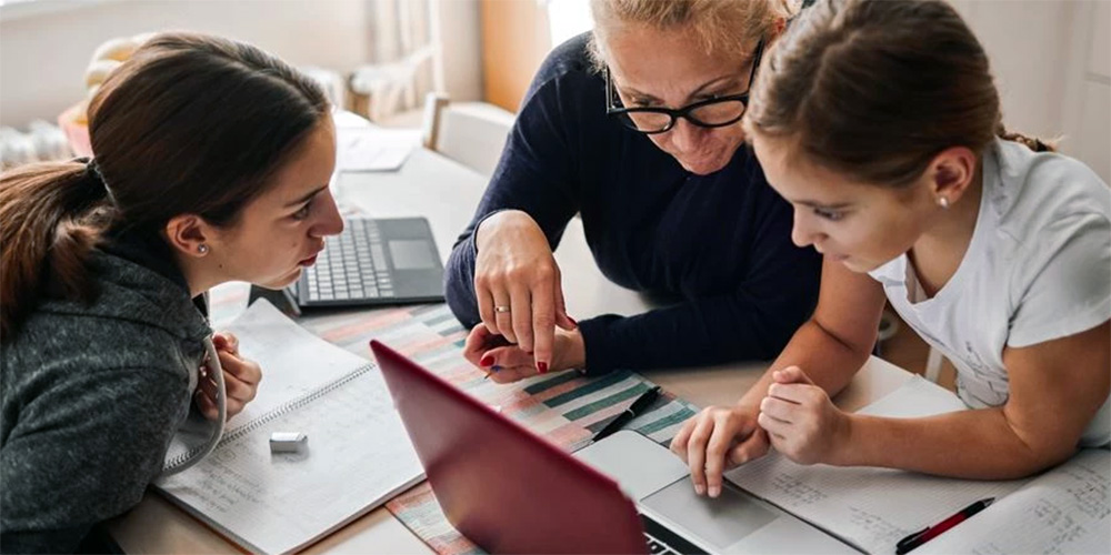 Parents helping their daughter with homework