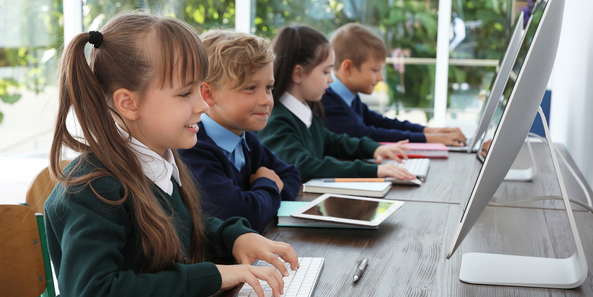 children in a row using computers