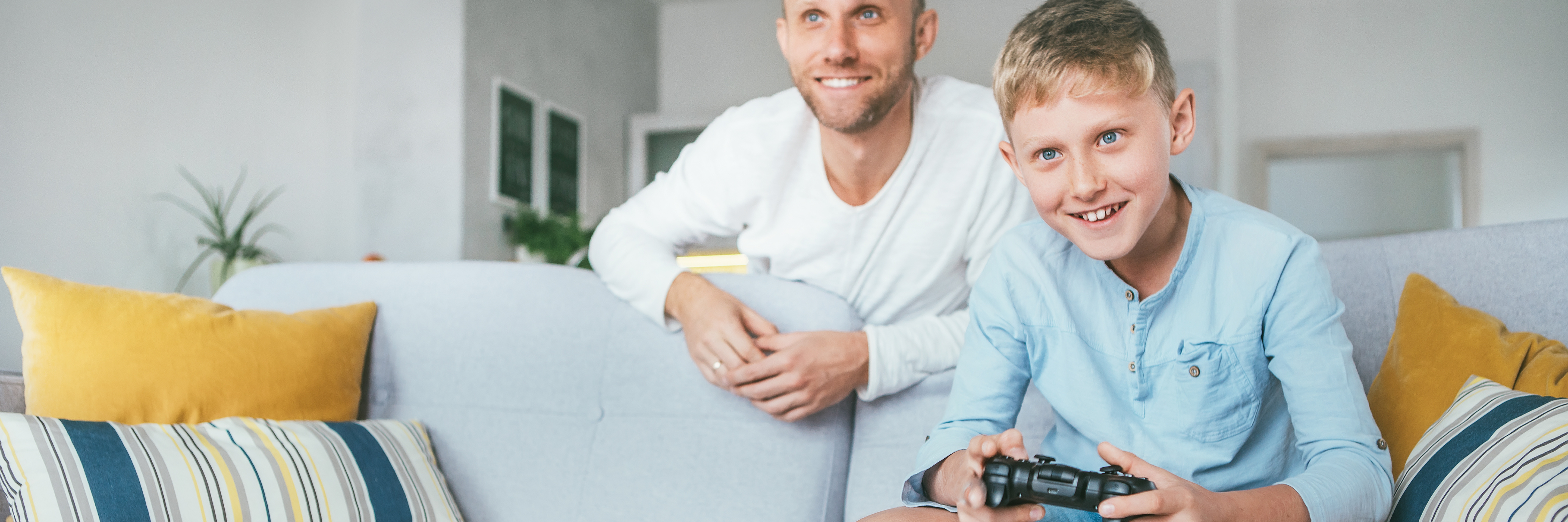man watching his son play computer games