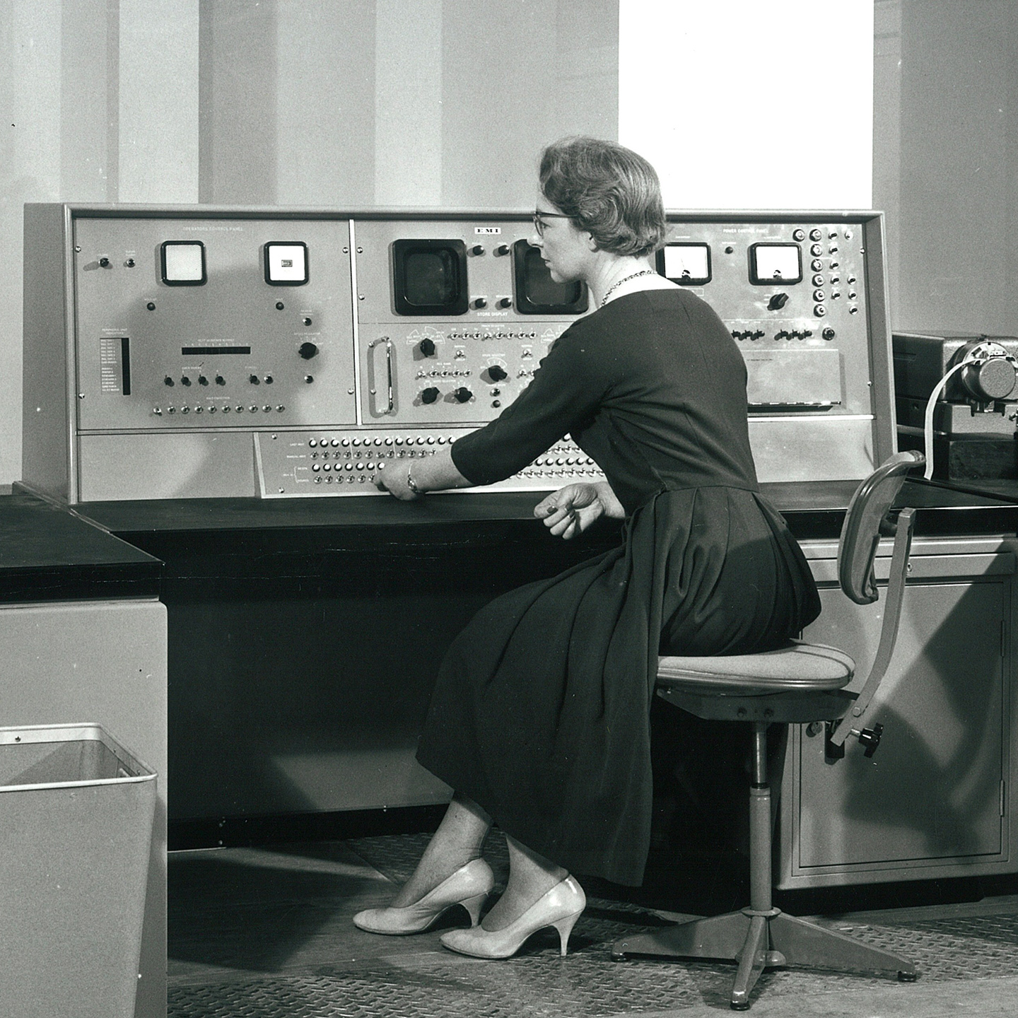 a black and white image from the 1960s of Audrey Stone sitting at an early computer - it's very big!