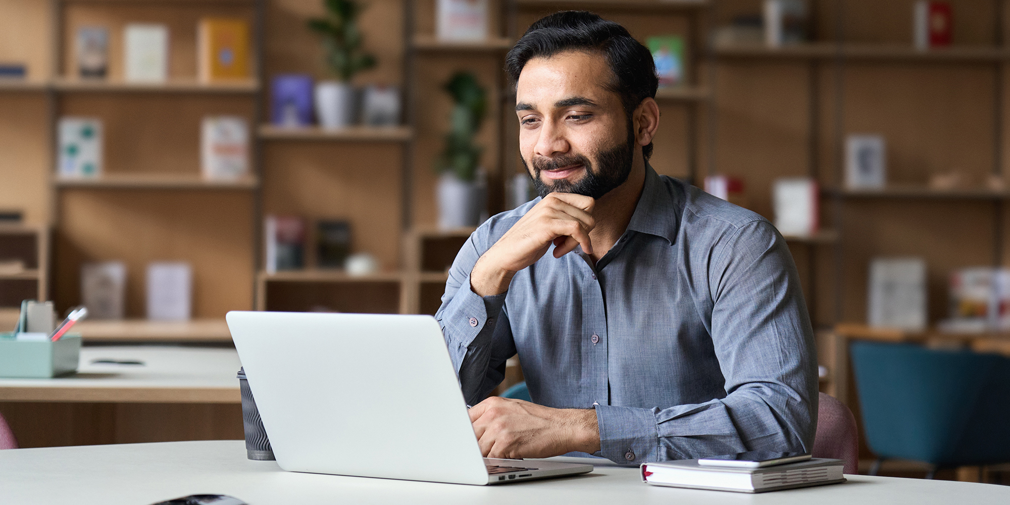 Man sitting at a desk with a laptop in front of him | Digital Wings how to keep passwords safe