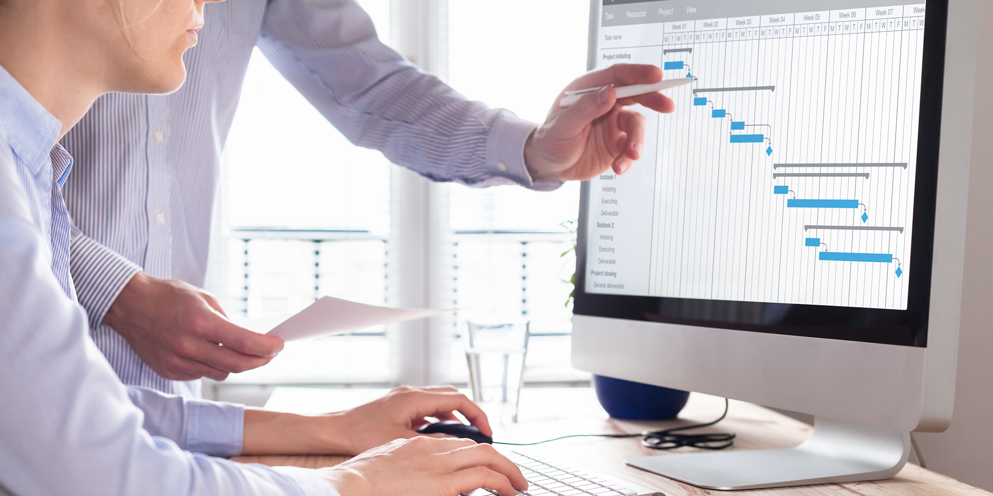 someone looking at a spreadsheet on a screen with data on it | Digital buisness skills