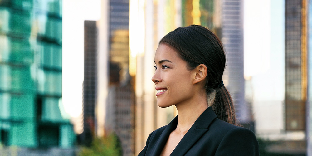 Smiling woman in front of city scene