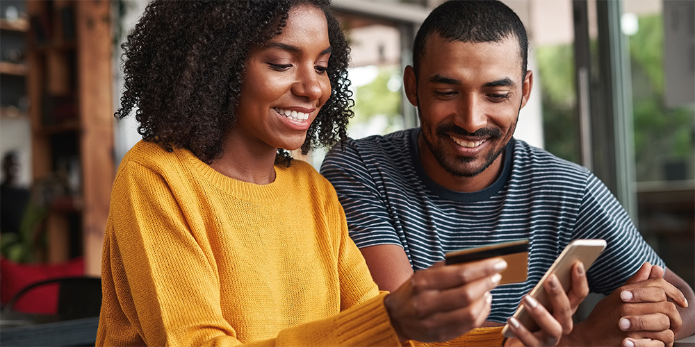 Couple excited to make a purchase on their phone