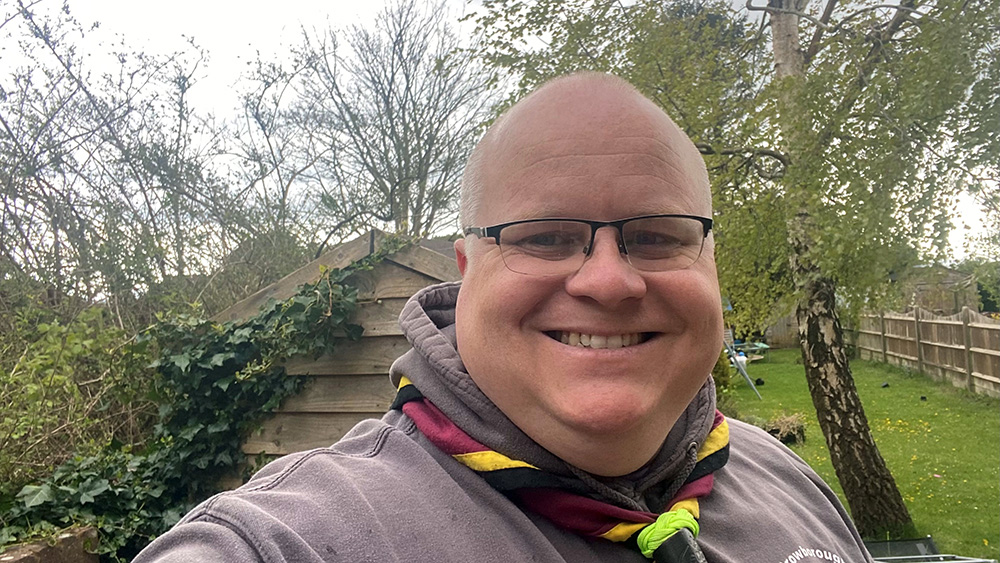 Cub scout leader smiling at the camera