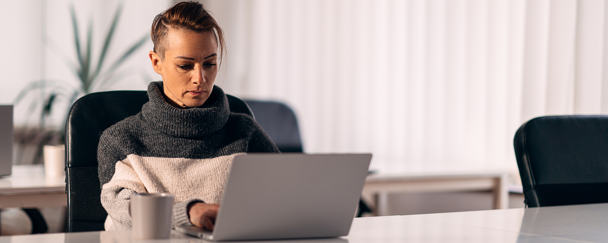 person sitting at a desk with a laptop in front of them | Digital Wings how to keep passwords safe