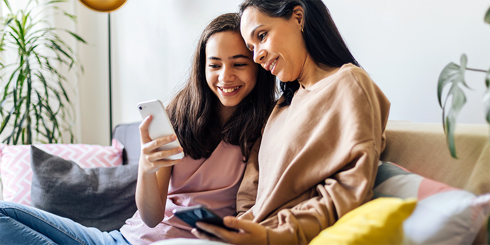 Mother and daughter looking at something on a phone