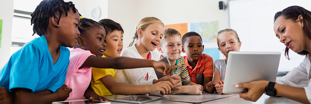 Teacher using a tablet to explain to her class