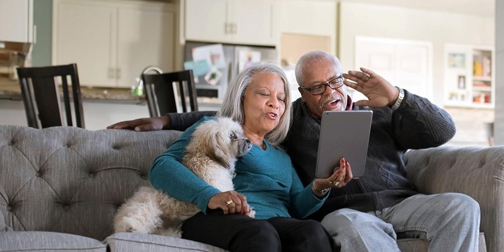 Retired couple talking to family on a tablet