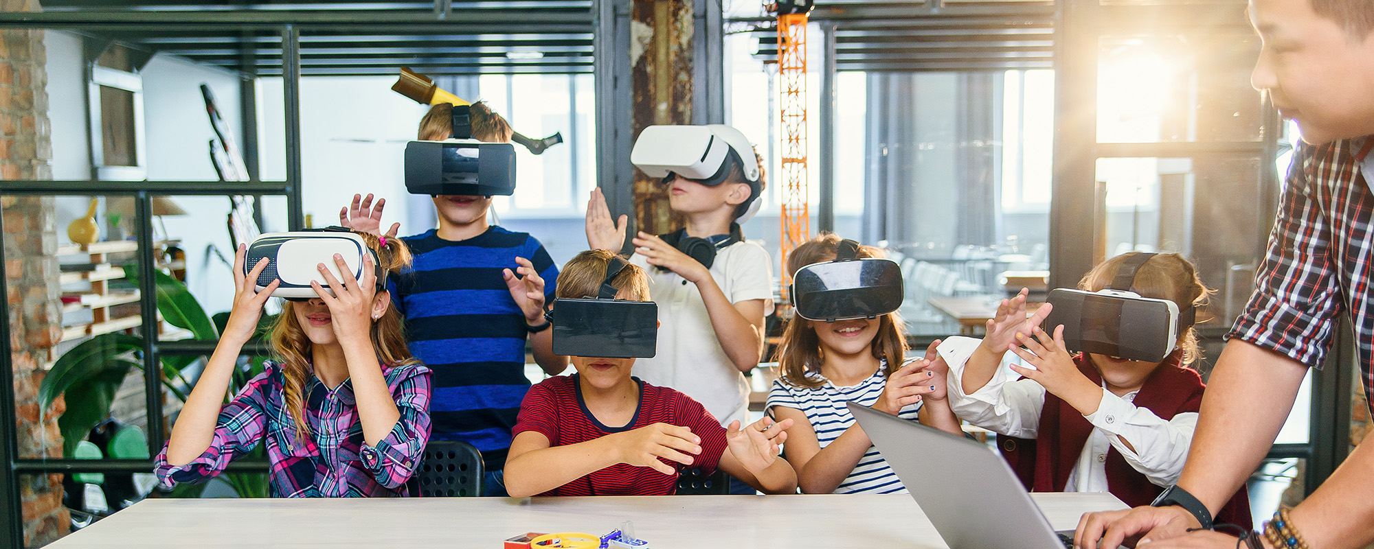 children using VR headsets in a classroom