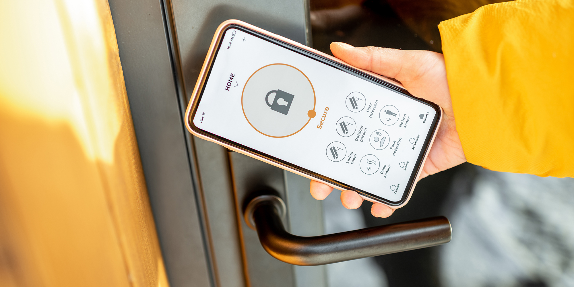 close up image of a hand holding a smart phone unlocking their smart front door | What is a smart home | Digital wings blog
