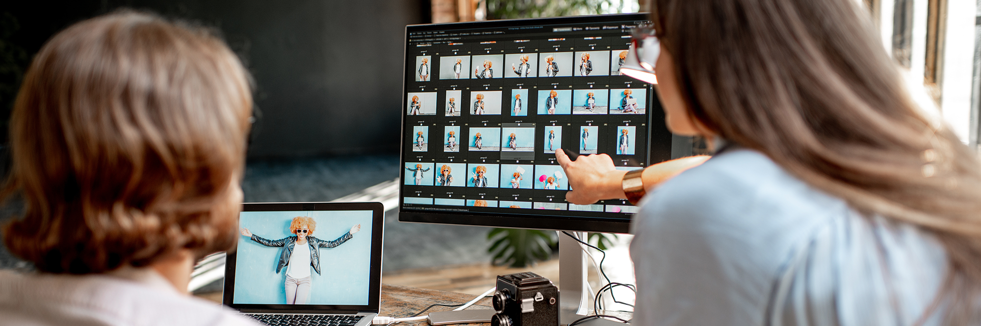 two people looking at a screen with photos on it | digital business skills
