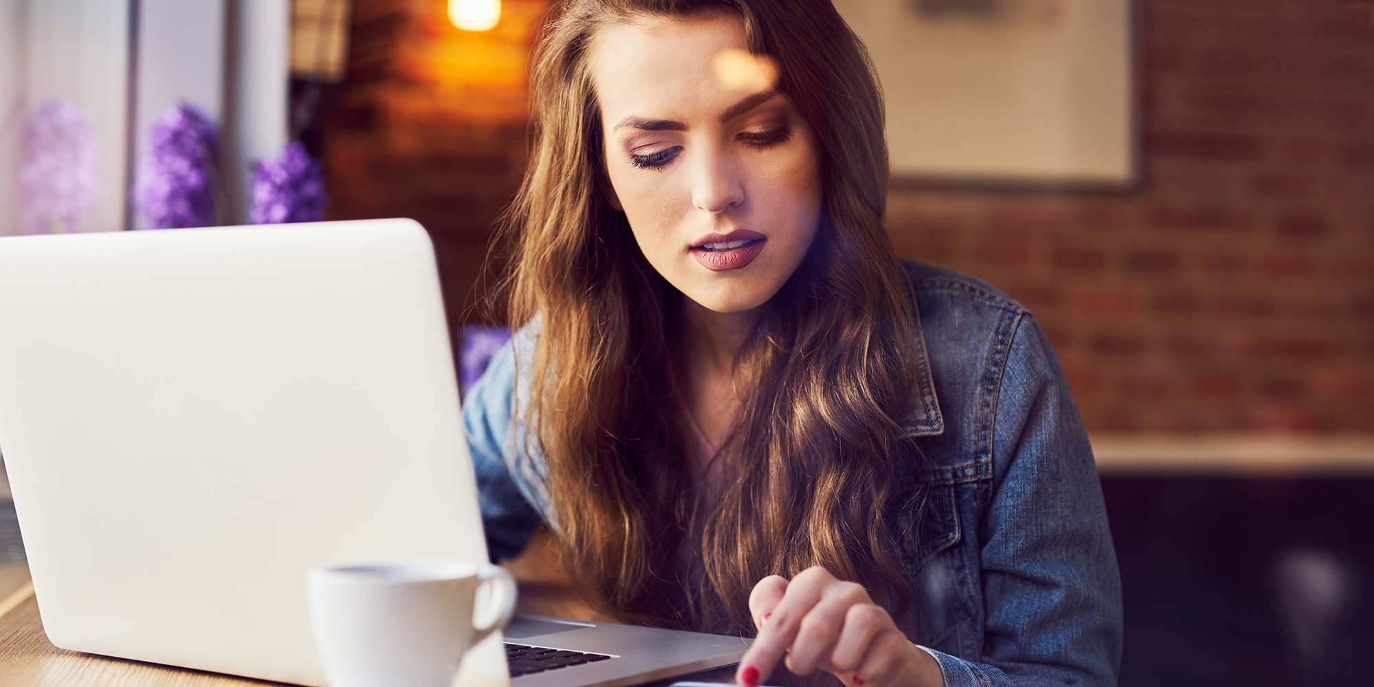 young woman looking concerned at her laptop | Digital Wings how to keep passwords safe