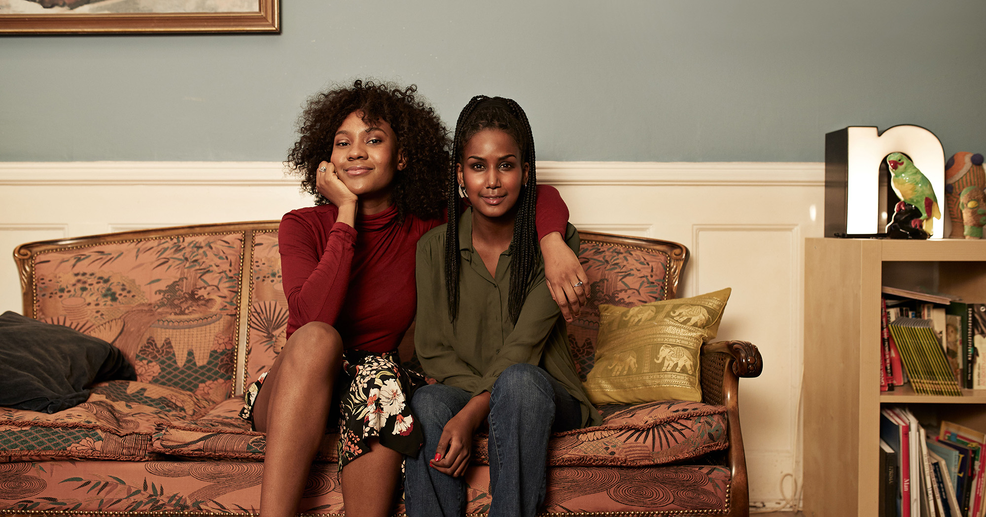 Two women sat on a sofa smiling | Online money management course | Digital Wings