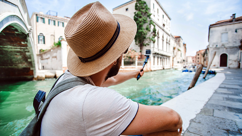 Man using an camera to record footage of Venice