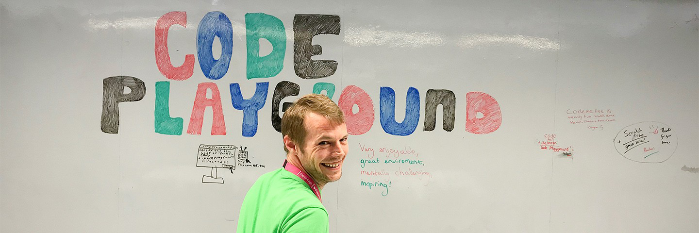 kev Garner in front of a whiteboard that says code playground