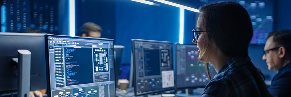 Woman looking at computer code in a lab