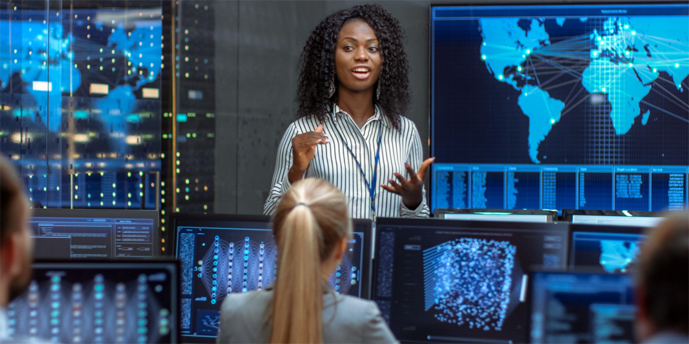 Lady in a meeting in front of a digital map