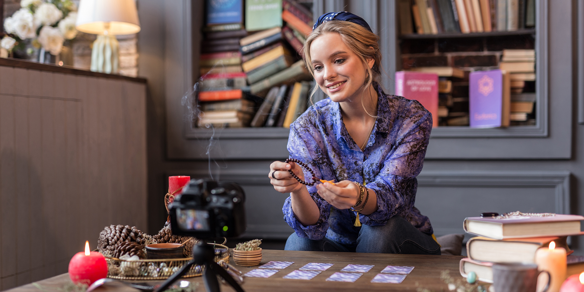 Woman holding a bracelet looking at a camera | digital wings social media for small businesses