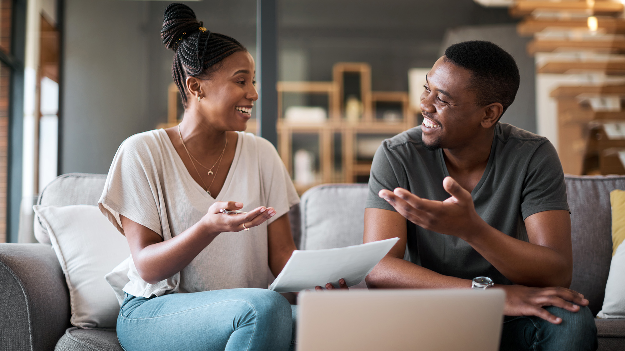 Couple on sofa looking at a laptop
